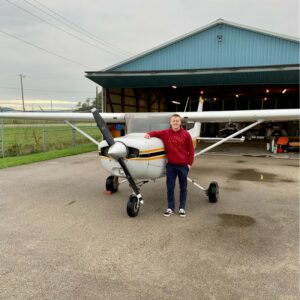 pilot training shows Fraser Fulton beside an airplane